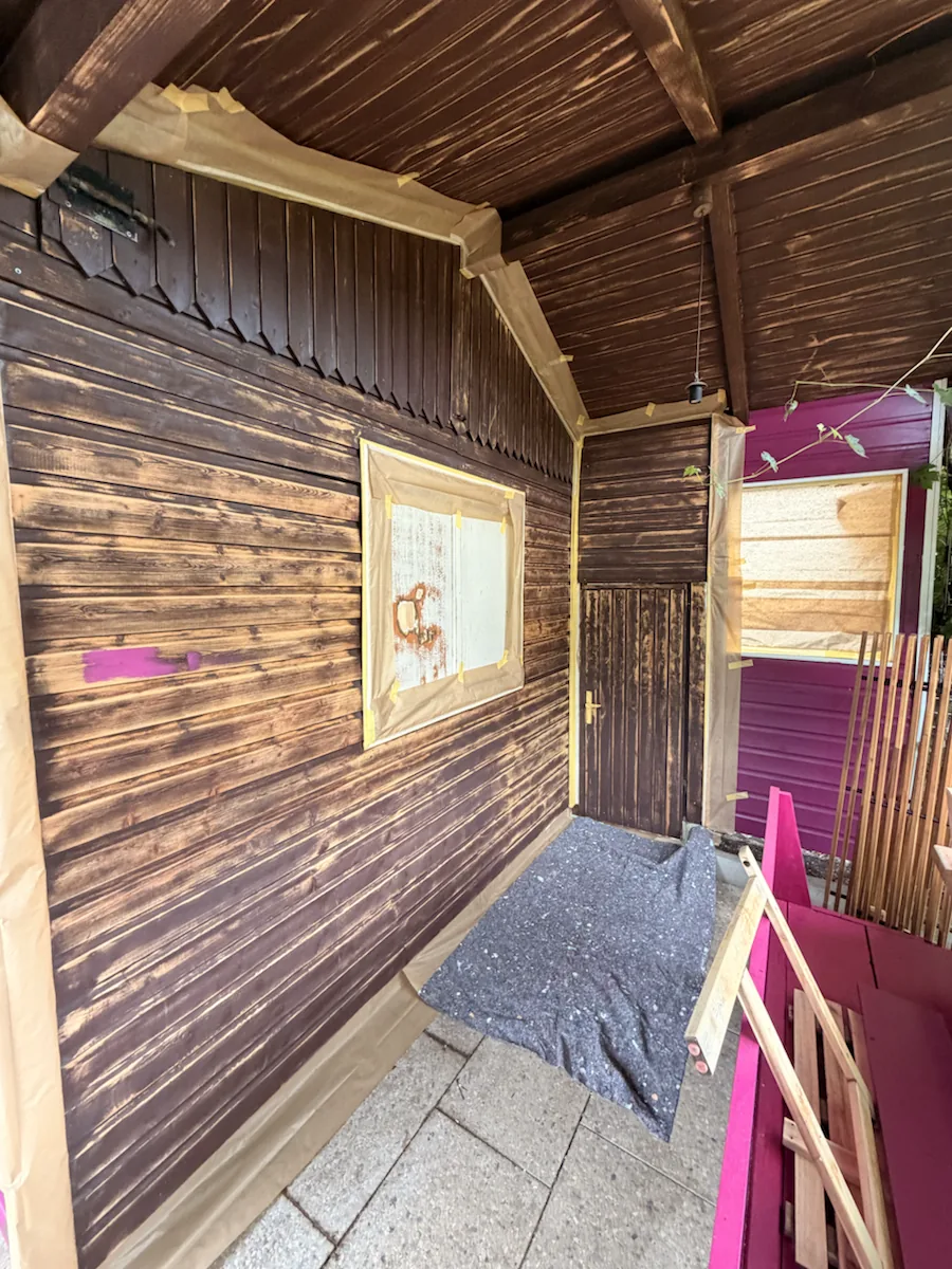 Dunkles Gartenhaus vor dem neuen Anstrich